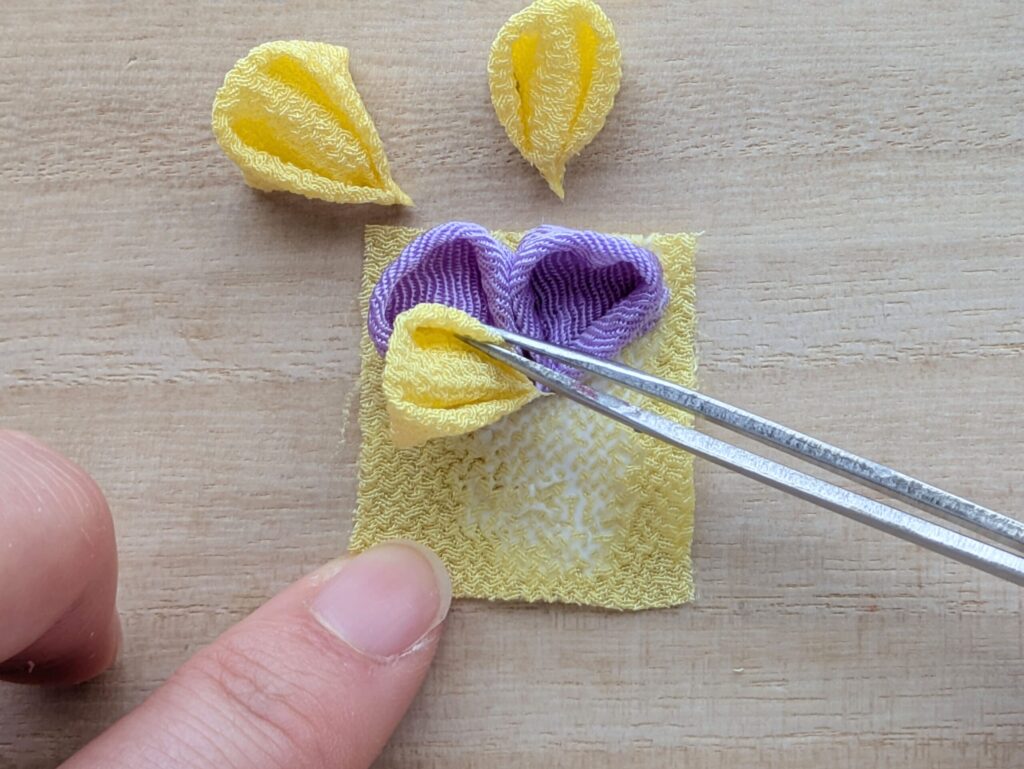 つまみ細工 パンジーの花びら小（黄）を紫の花びらに重ねて配置する工程